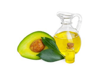 Photo of Oil, green leaves and fresh cut avocado isolated on white