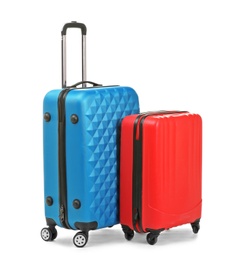 Photo of Packed stylish suitcases on white background. Traveler's luggage