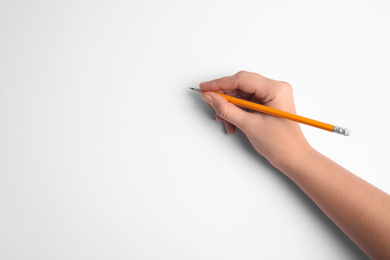 Woman holding pencil on white background, top view