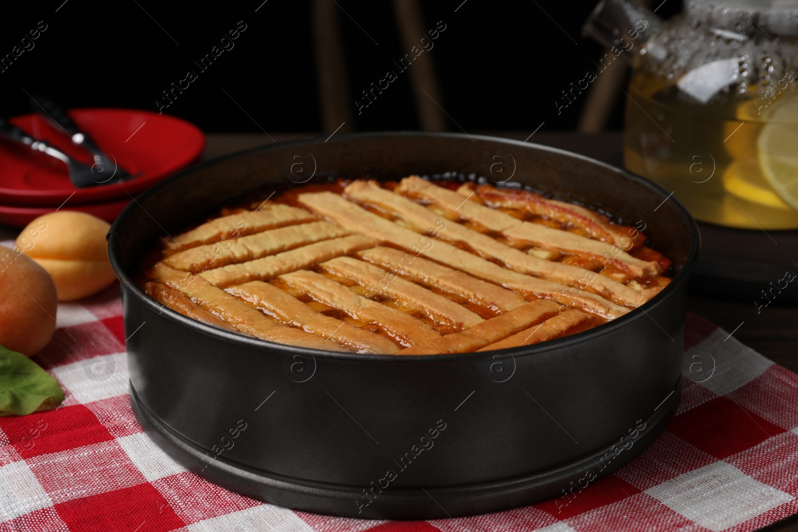 Photo of Delicious apricot pie in baking dish on table, closeup