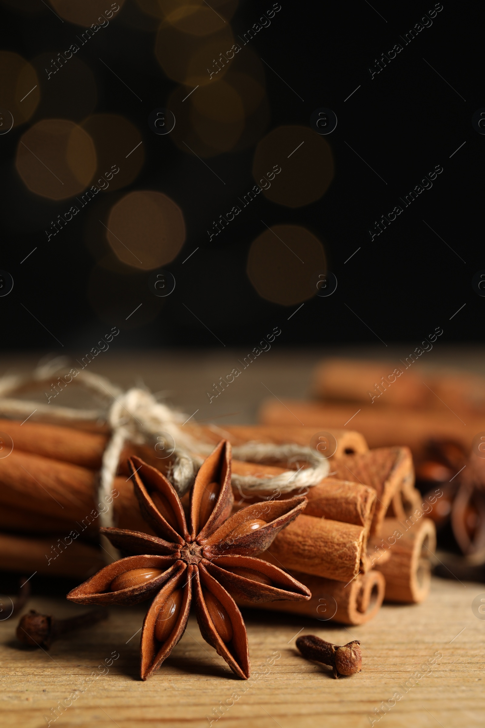 Photo of Different aromatic spices on wooden table, closeup