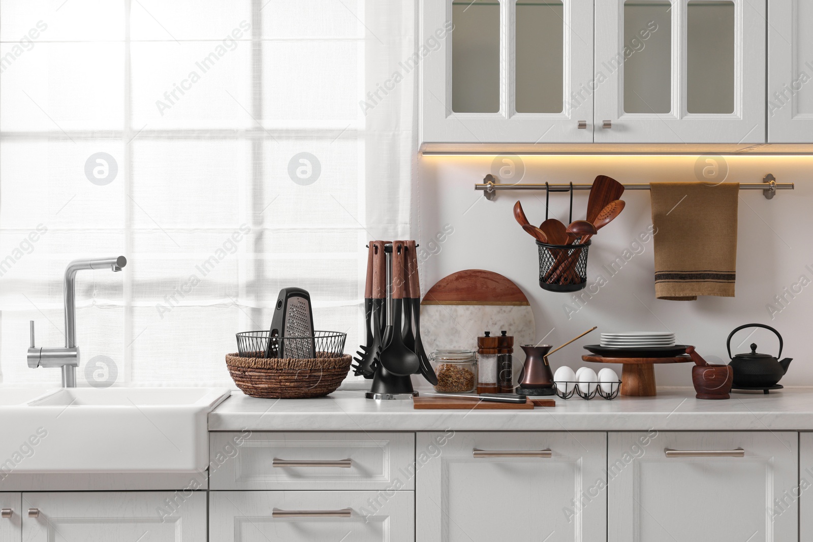 Photo of Set of different utensils and dishes on countertop in kitchen