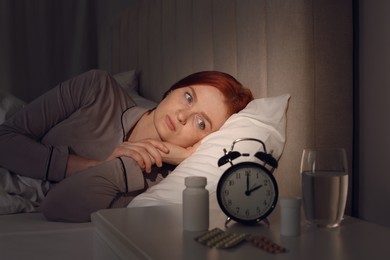 Photo of Woman suffering from insomnia in bed at home