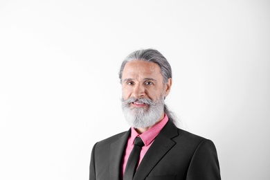 Handsome bearded mature man in suit on white background