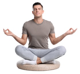 Photo of Handsome man meditating on white background. Harmony and zen