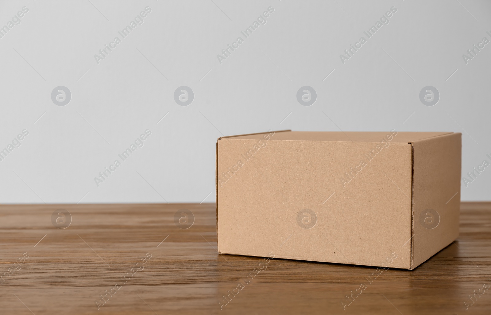 Photo of Cardboard box on wooden table