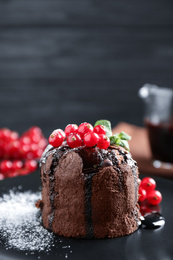 Delicious warm chocolate lava cake with mint and berries on plate, closeup. Space for text