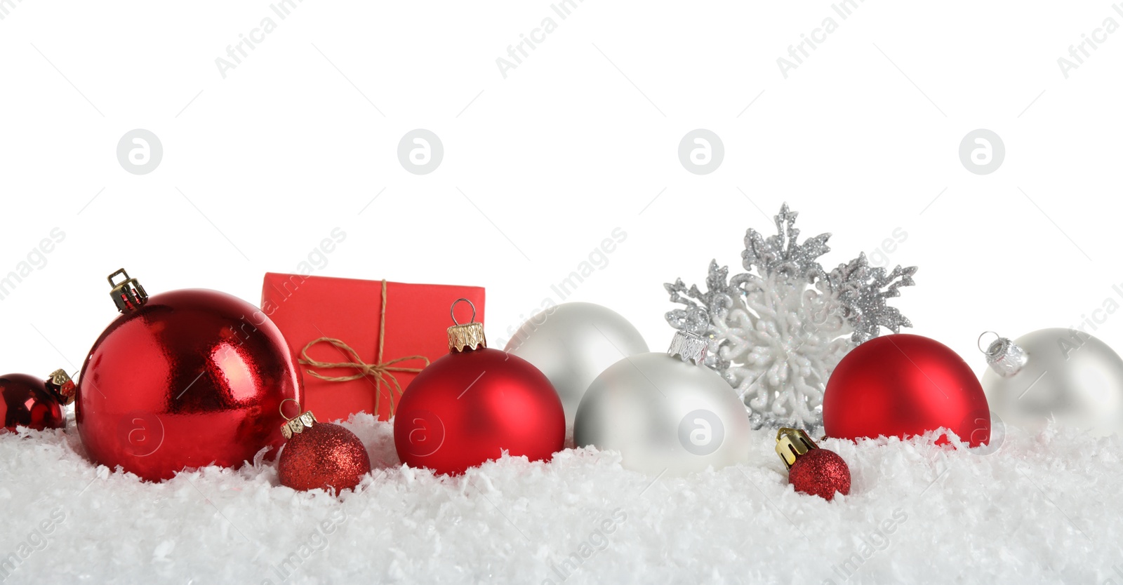 Photo of Christmas tree decoration on artificial snow against white background