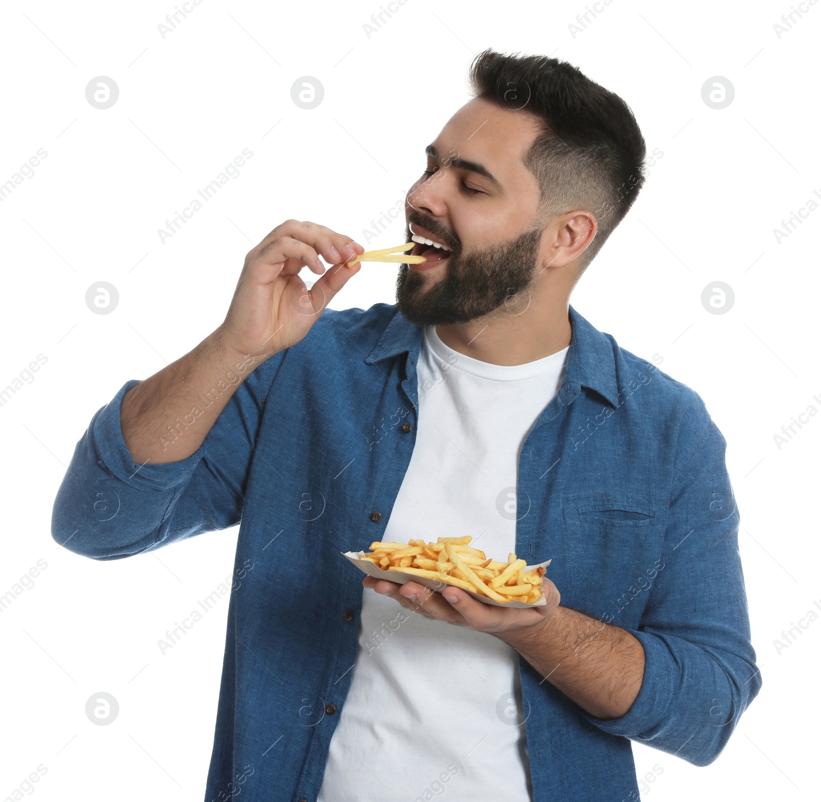 Photo of Young man eating French fries on white background