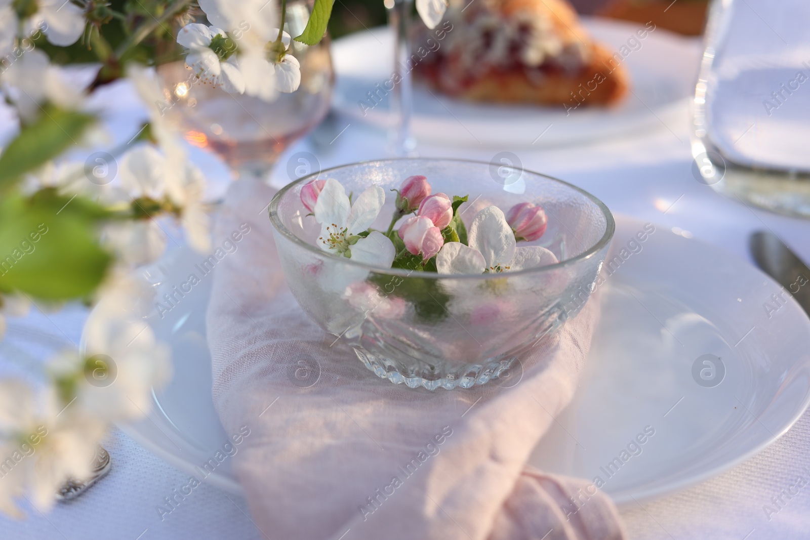 Photo of Stylish table setting with beautiful spring flowers in garden