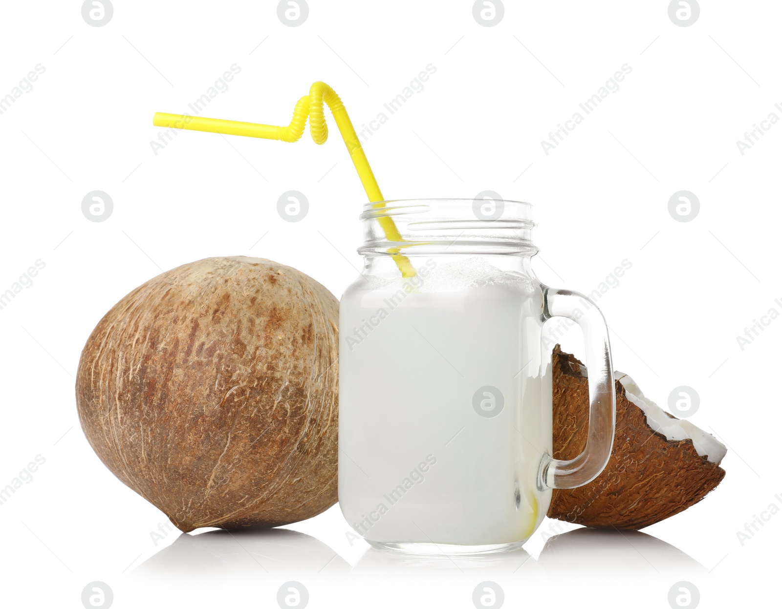 Photo of Mason jar of drink and coconuts on white background