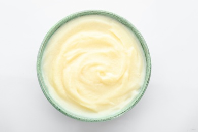 Photo of Bowl with tasty mashed potatoes on white background, top view