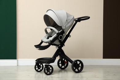 Photo of Baby carriage. Modern pram near beige wall