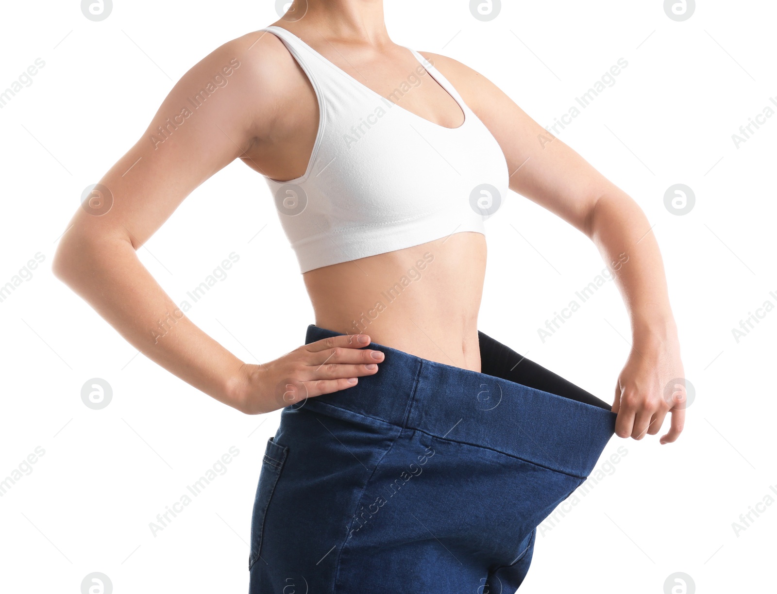 Photo of Young slim woman wearing oversized jeans on white background, closeup