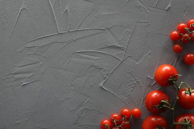 Photo of Food photography. Delicious ripe tomatoes on grey textured table, flat lay with space for text