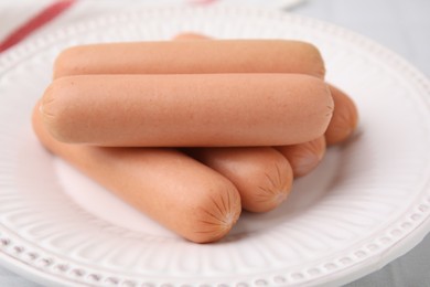 Photo of Many delicious boiled sausages on plate, closeup