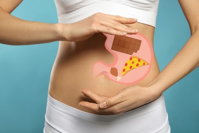 Woman with image of stomach full of junk food drawn on her belly against light blue background, closeup. Unhealthy eating habits