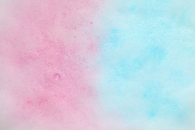 Photo of Colorful foam after dissolving bath bomb in water, closeup