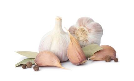 Photo of Fresh garlic bulbs and cloves with seasonings isolated on white. Organic food
