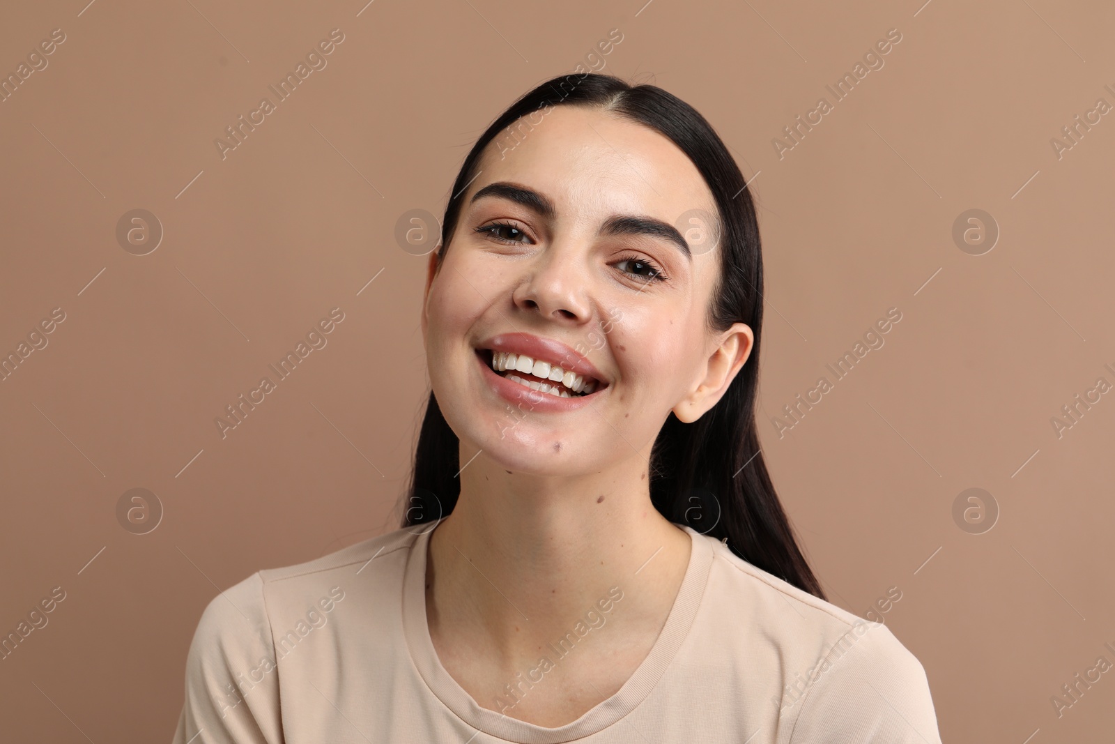 Photo of Beautiful woman with clean teeth smiling on beige background