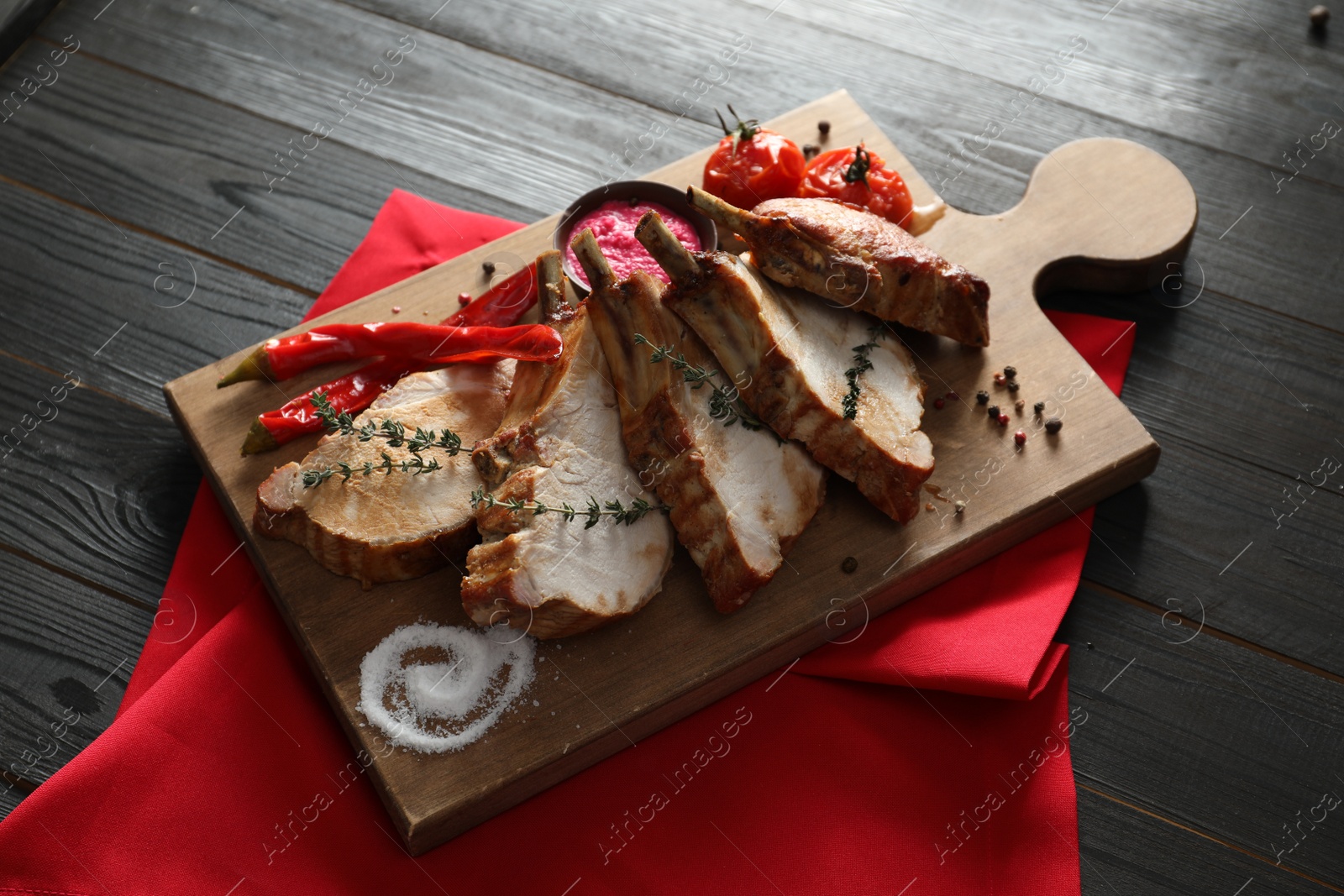 Photo of Delicious roasted ribs served on wooden table