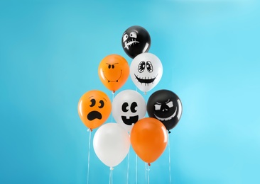 Photo of Color balloons for Halloween party on blue background