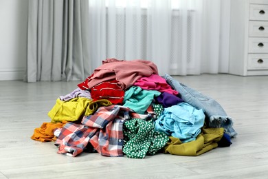 Photo of Pile of dirty clothes on floor indoors