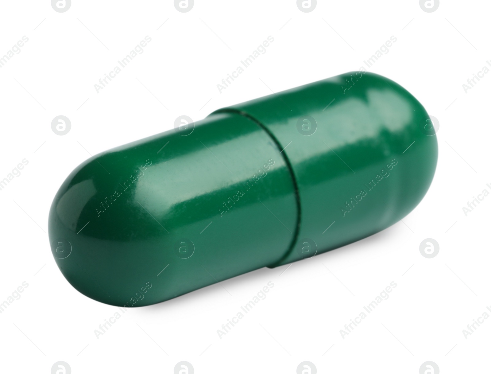 Photo of One green pill on white background. Medicinal treatment