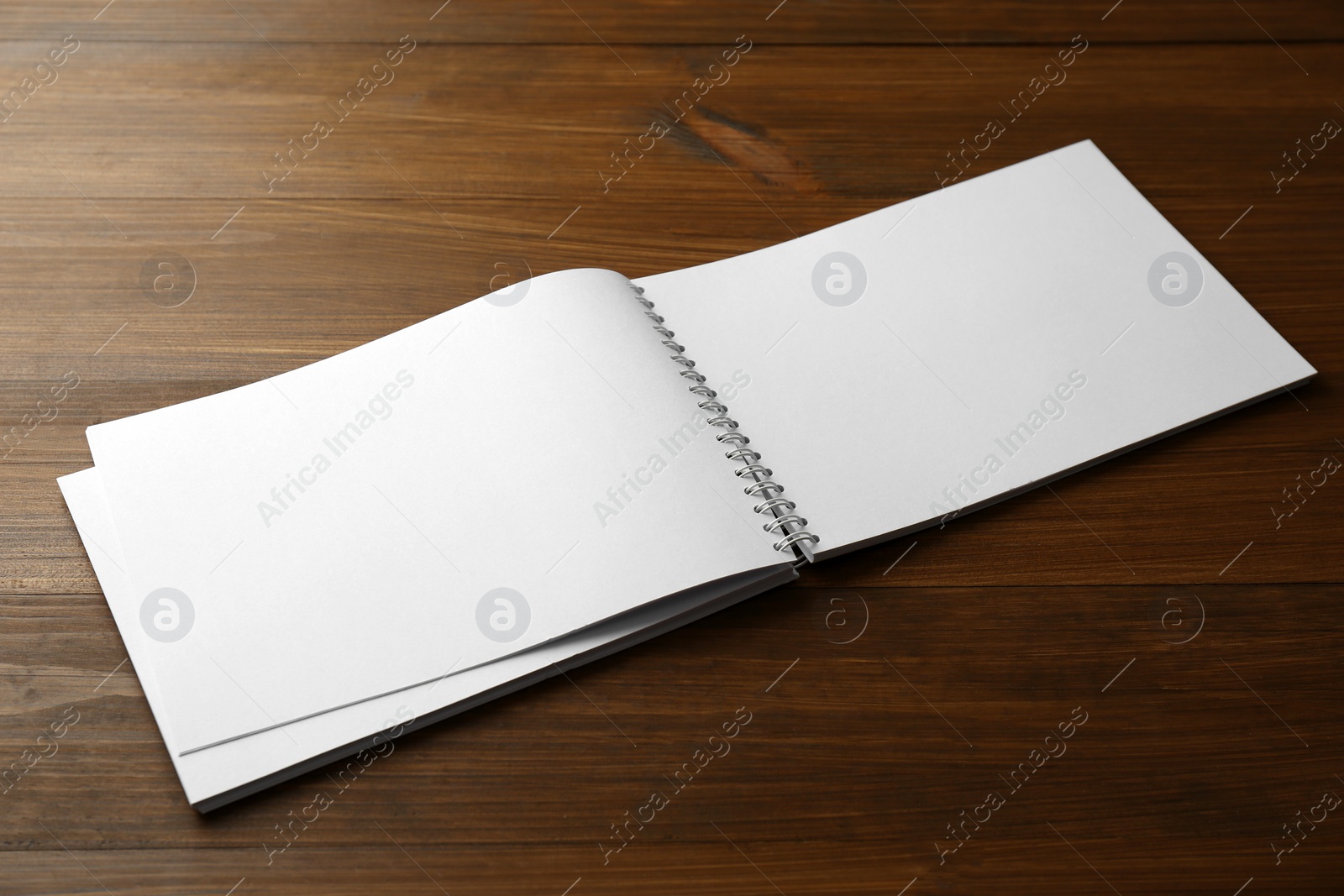 Photo of Blank paper brochure on wooden table. Mockup for design