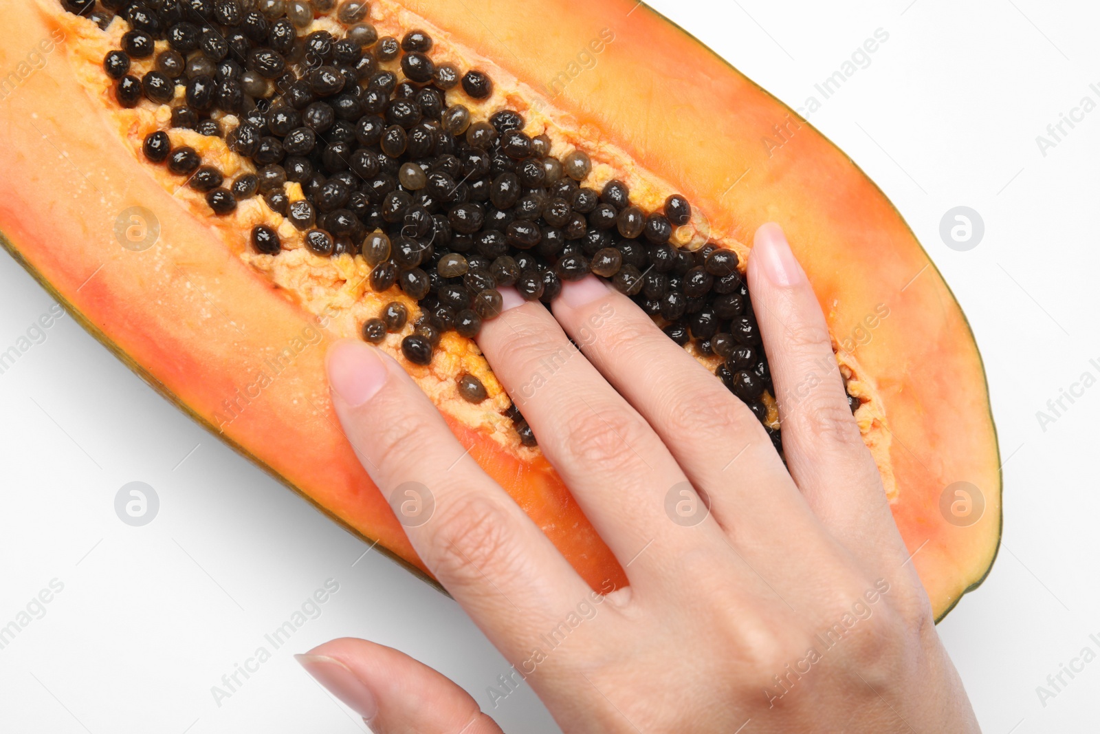 Photo of Young woman touching half of papaya on white background, closeup. Sex concept