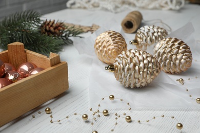 Photo of Composition with beautiful Christmas baubles on white wooden table