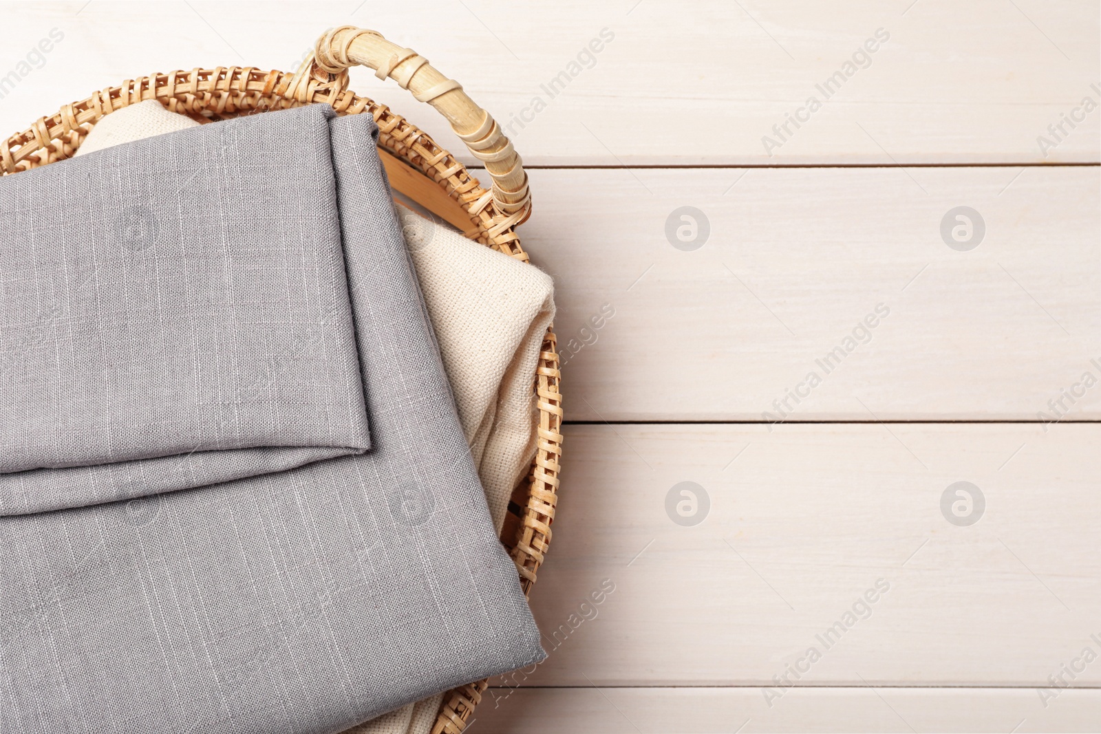 Photo of Hemp cloths on white wooden table, top view. Space for text