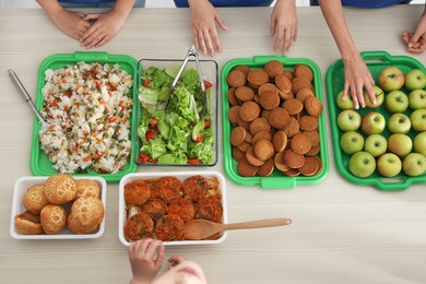 Table with food prepared by volunteers for poor people, top view