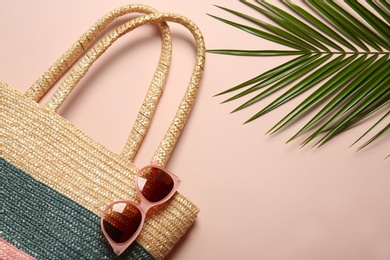 Flat lay composition with palm leaf and beach objects on color background