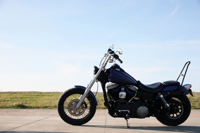 Modern black motorcycle on sunny day outdoors