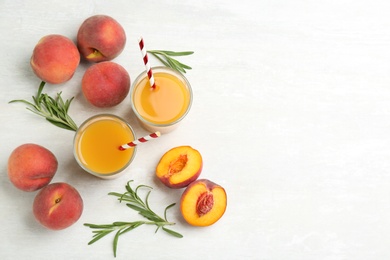 Natural freshly made peach juice on white table, flat lay. Space for text