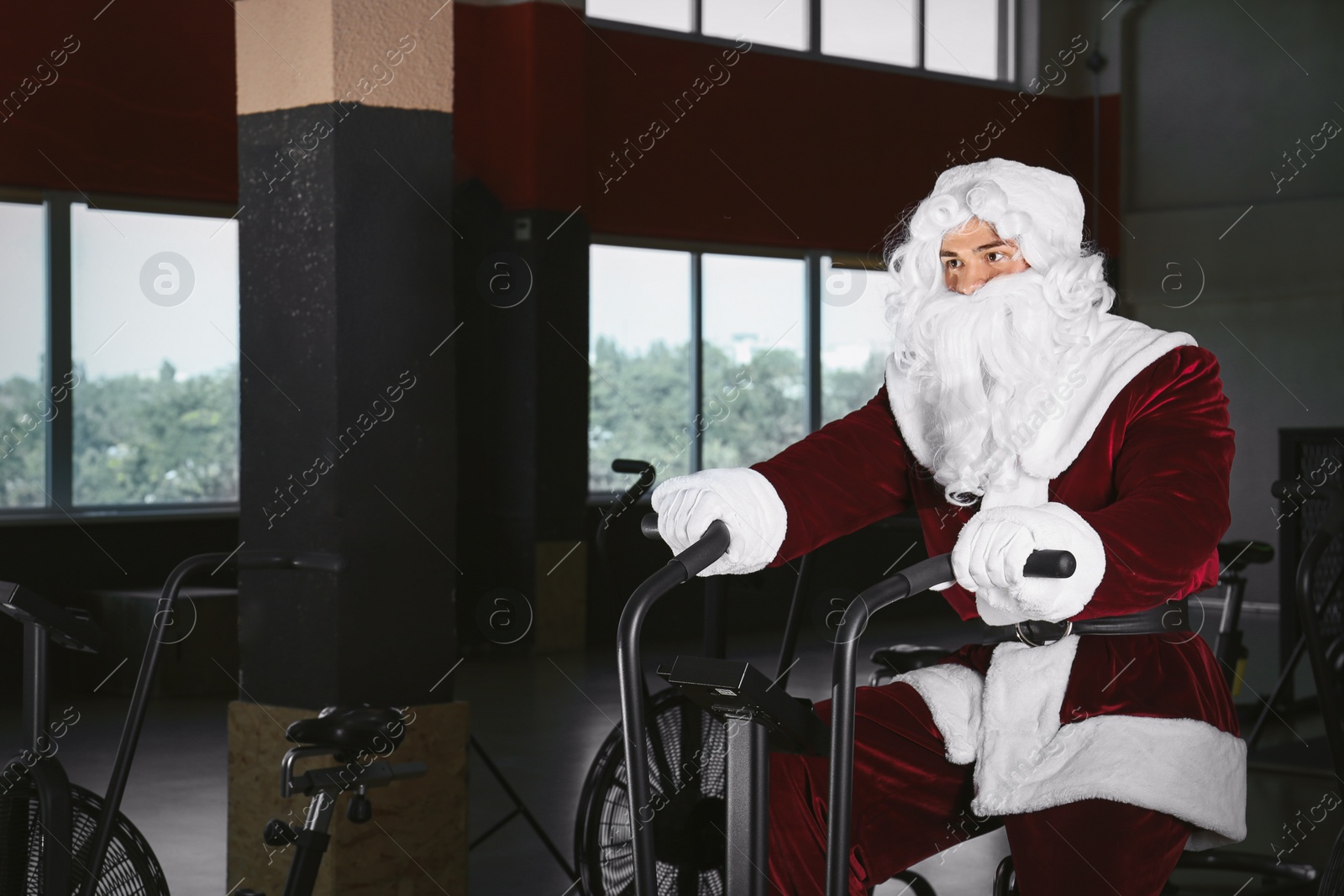 Photo of Young Santa Claus training in modern gym