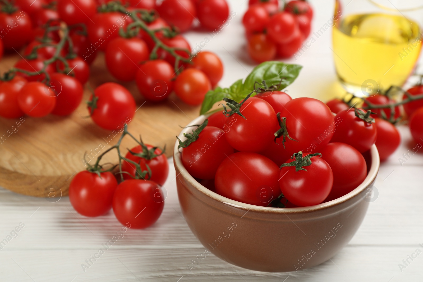 Photo of Fresh ripe cherry tomatoes on white wooden table