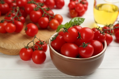 Fresh ripe cherry tomatoes on white wooden table