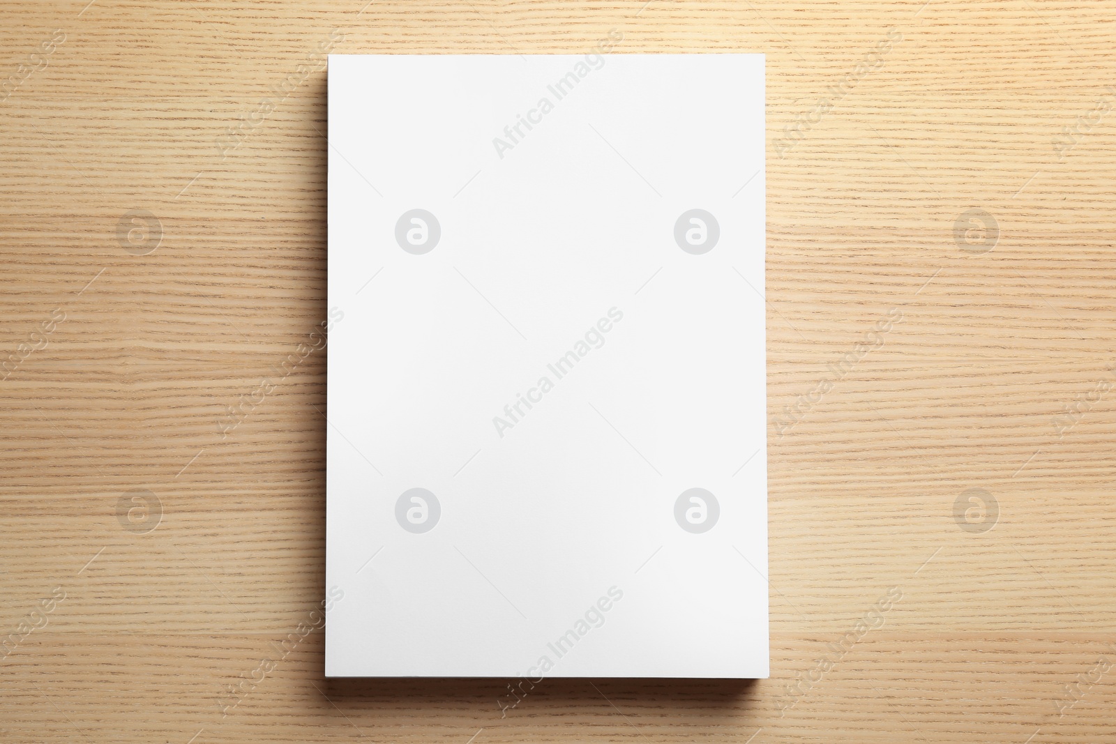 Photo of Stack of blank paper sheets for brochure on wooden background, top view. Mock up