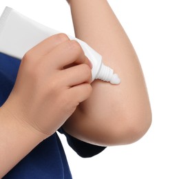 Child applying ointment onto elbow isolated on white, closeup