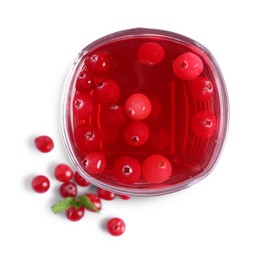 Photo of Tasty cranberry juice in glass and fresh berries isolated on white, top view