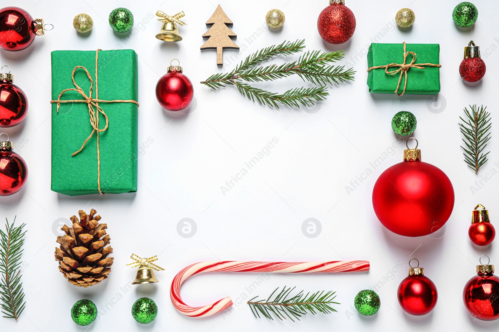 Photo of Frame of Christmas tree branches and festive decoration on white background, top view. Space for text