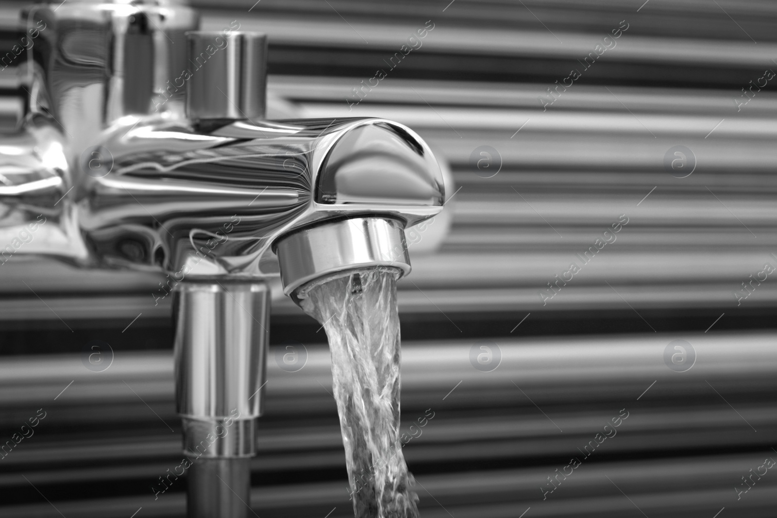 Image of Water flowing from tap in bathroom, closeup