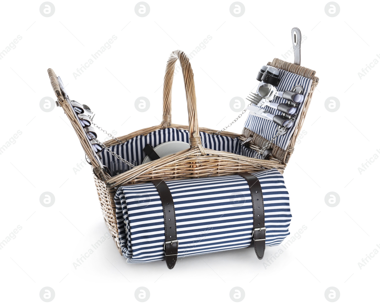 Photo of Wicker basket with picnic essentials and blanket on white background