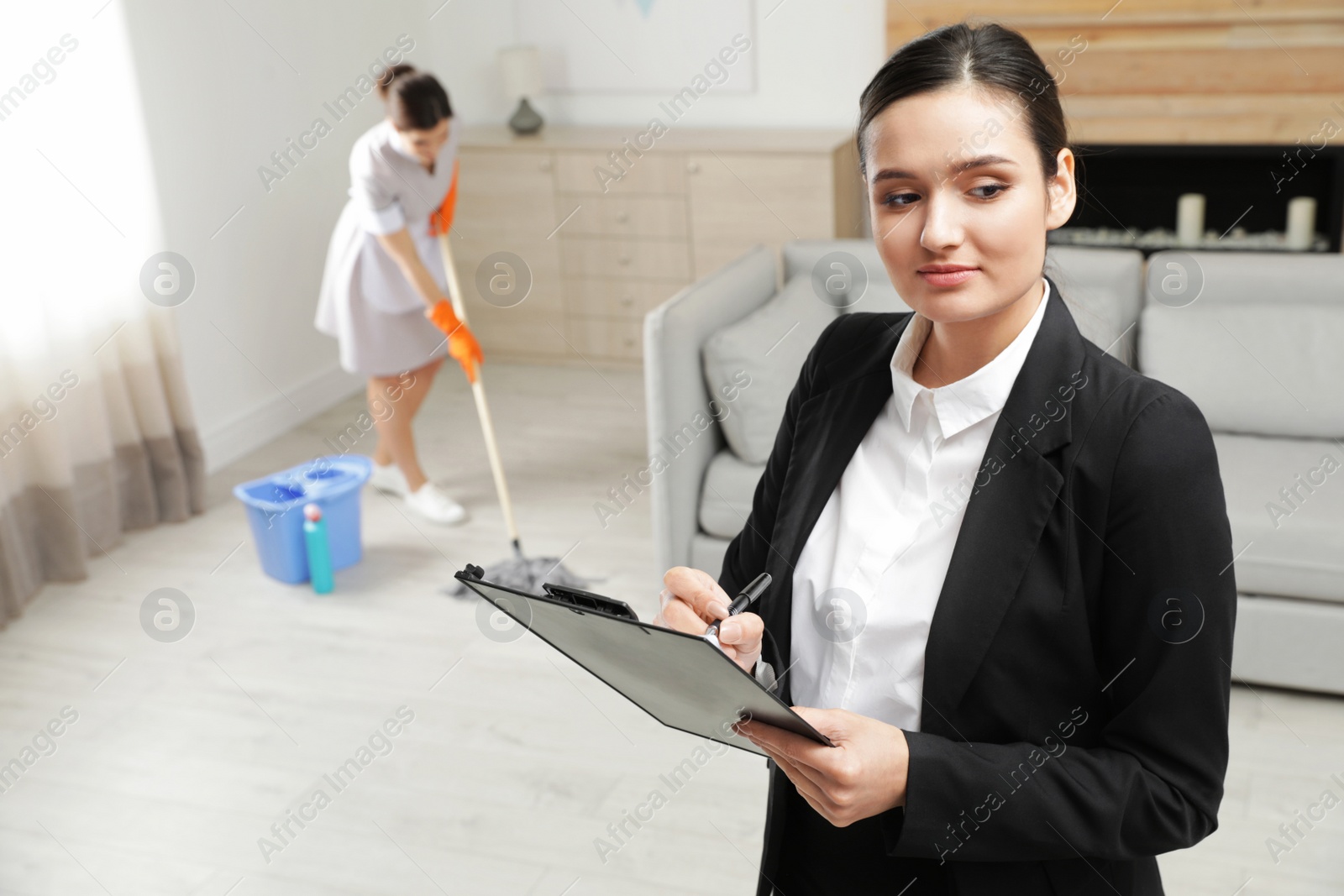 Photo of Housekeeping manager checking maid work in hotel room
