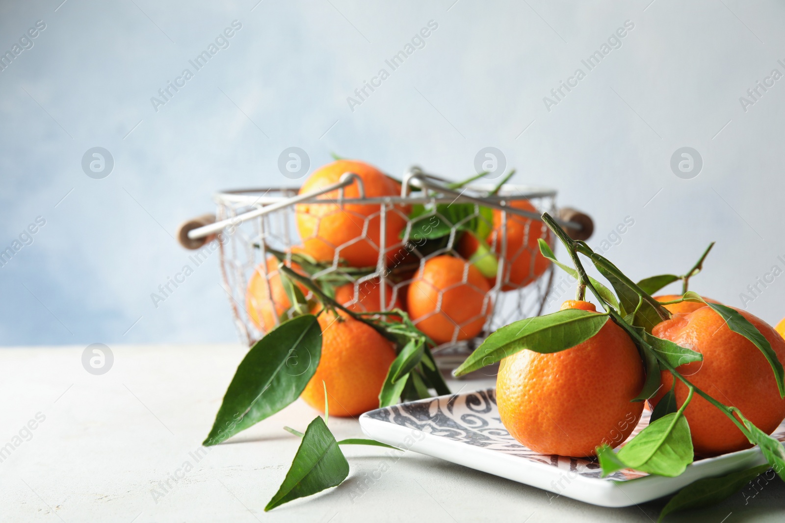 Photo of Plate with tasty ripe tangerines on table. Space for text