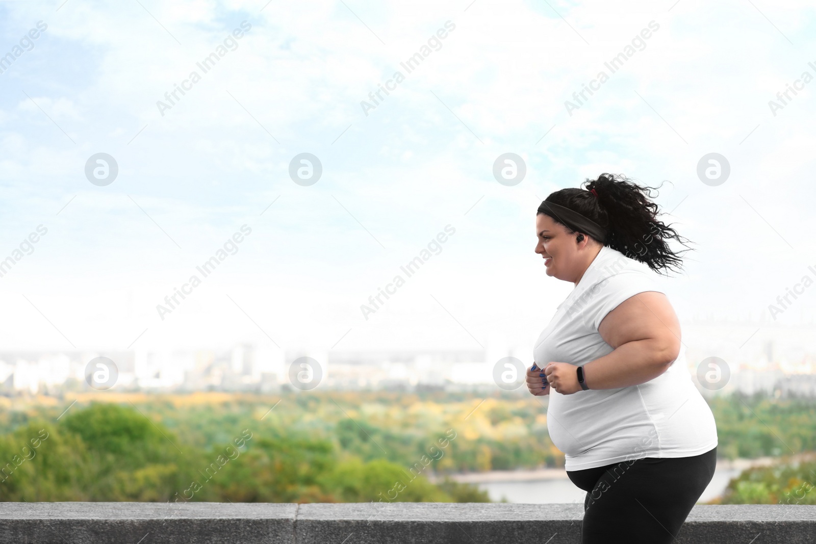 Photo of Beautiful overweight woman running outdoors. Fitness lifestyle