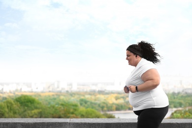 Photo of Beautiful overweight woman running outdoors. Fitness lifestyle