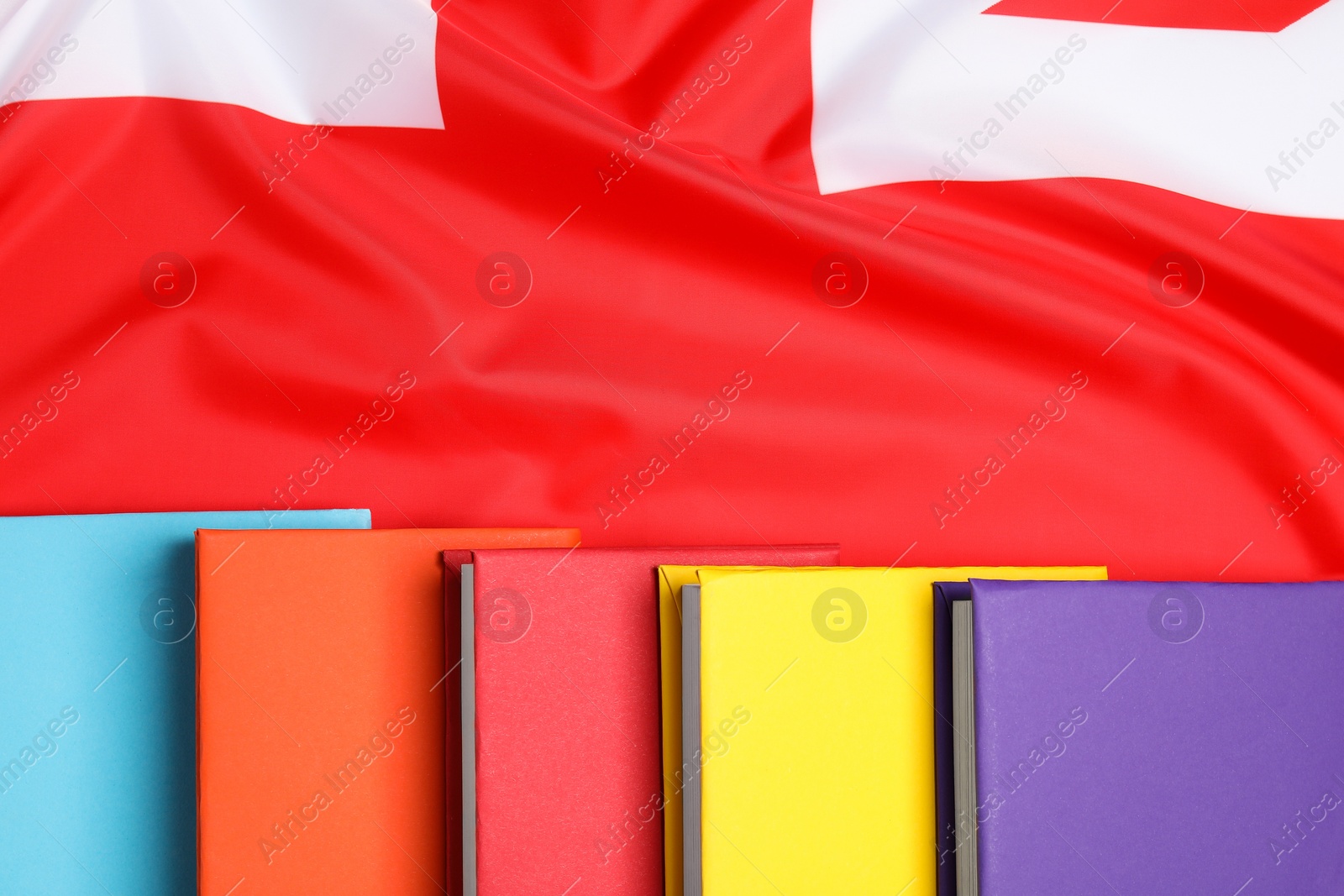Photo of Learning foreign language. Different books on flag of United Kingdom, top view with space for text